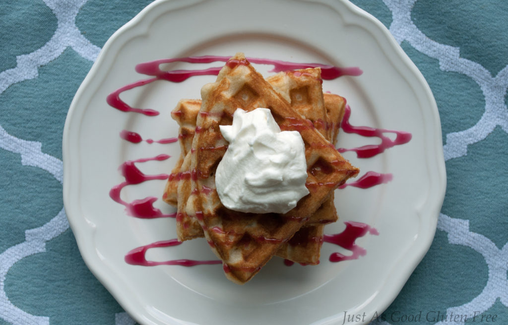 Gluten Free Waffles with whipped cream and choke cherry sauce top view