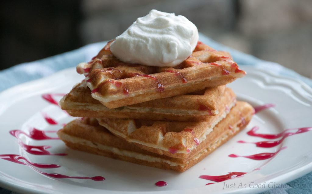Gluten Free Waffles with whipped cream and choke cherry sauce side view