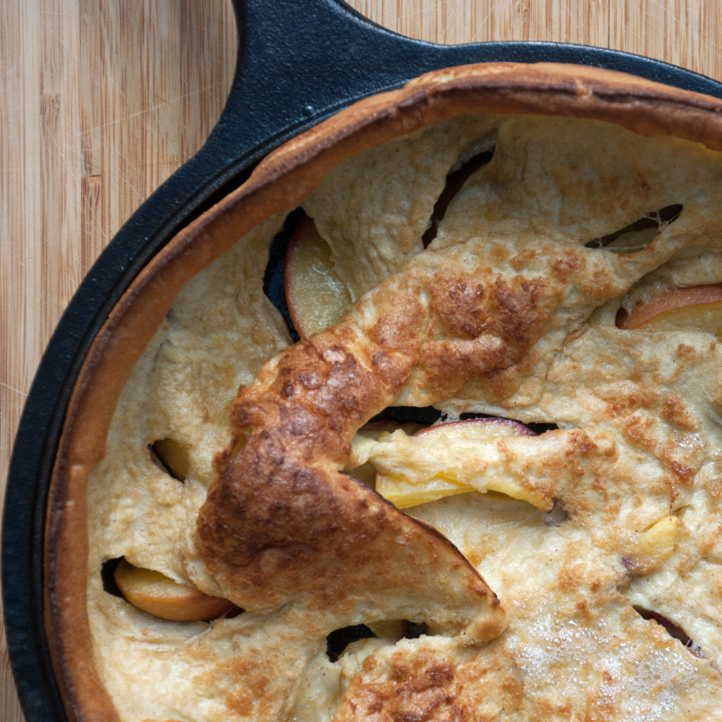 corner of peach dutch baby pancake gluten free with no powdered sugar