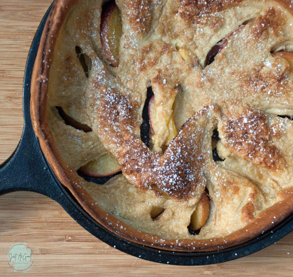 Gluten free peach dutch baby pancake with powdered sugar