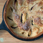 Gluten free peach dutch baby pancake with powdered sugar