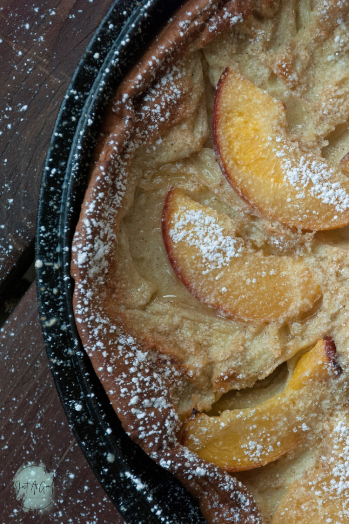 Gluten free dutch baby pancake with peaches on top