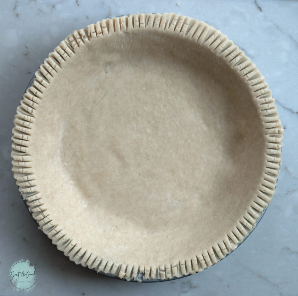 gluten free whole pie crust dough in metal pan