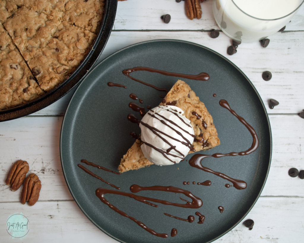 Gluten Free Chocolate Chip Oatmeal Skillet Cookie top view with ice cream and chocolate sauce