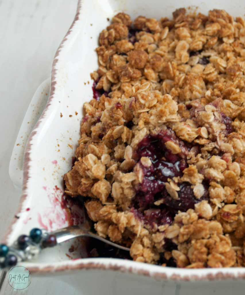 Gluten free cherry crisp in dish with spoon