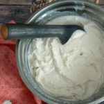 Bowl of coconut ice cream with scoop