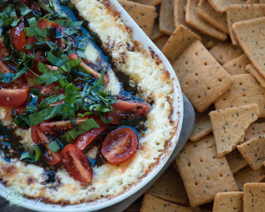 Gluten Free Warm Goat Cheese Caprese Dip up close with crackers