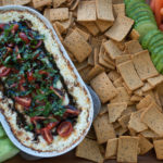 Gluten Free Warm Goat Cheese Caprese Dip Whole Platter with crackers cucumbers tomatoes and carrots