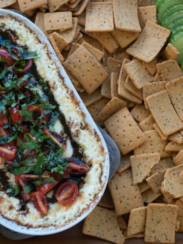 Gluten Free Warm Goat Cheese Caprese Dip Whole Platter with crackers cucumbers tomatoes and carrots