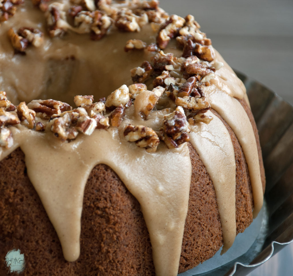 Gluten Free Apple Cake with brown sugar and cinnamon frosting and pecan praline topping
