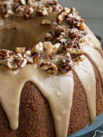 Gluten Free Apple Cake with brown sugar and cinnamon frosting and pecan praline topping