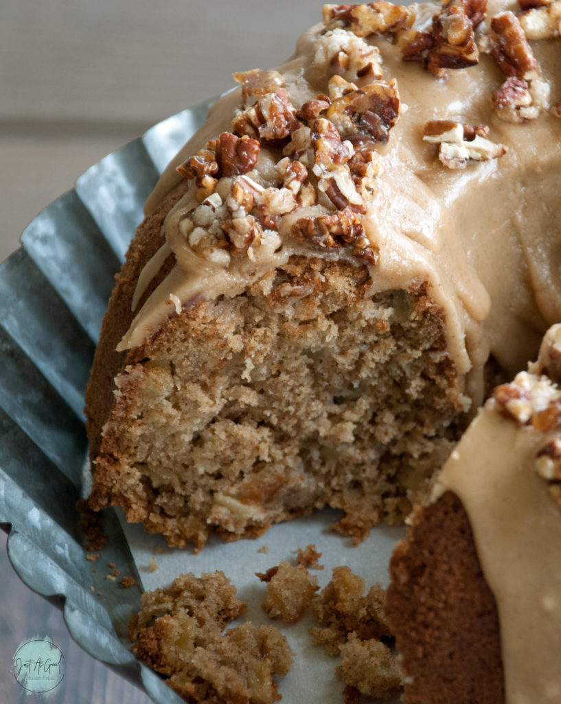 Inside view of Gluten Free Apple Cake with brown sugar and cinnamon frosting and pecan praline topping