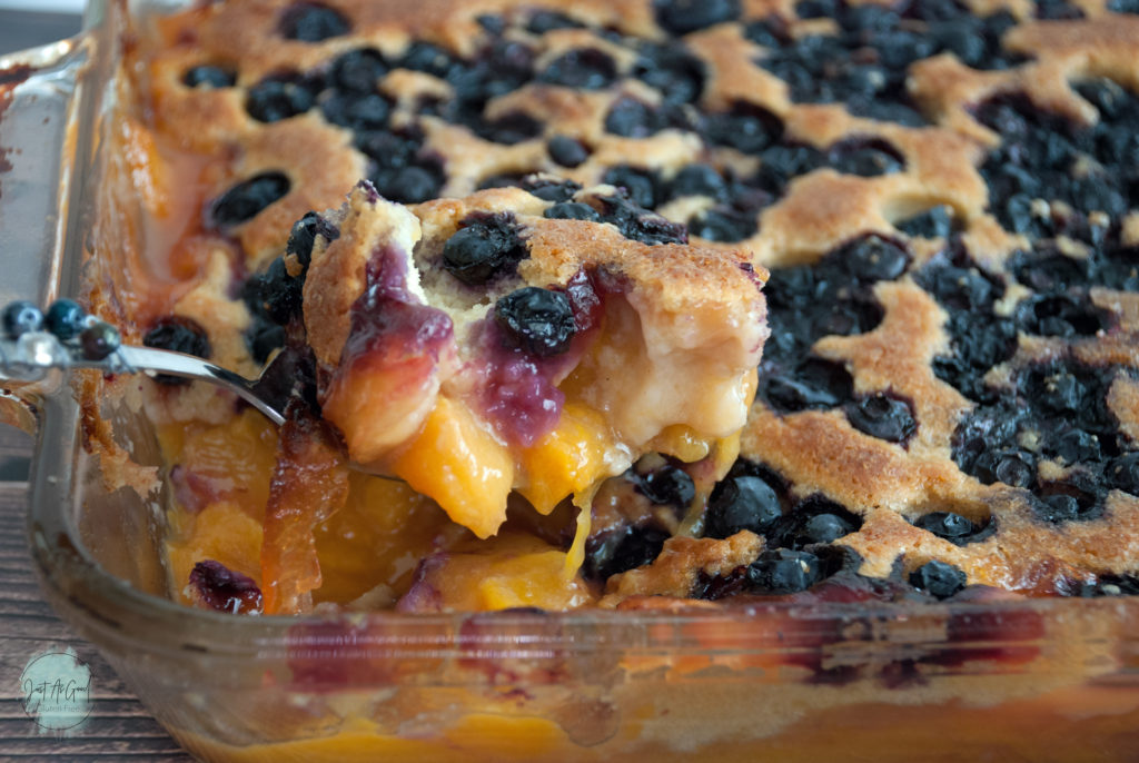 Spoon of gluten free blueberry peach cobbler