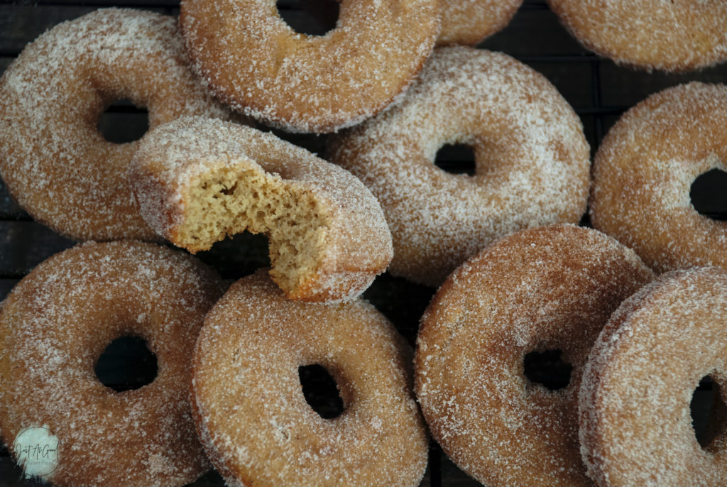 Pile of Gluten Free Baked Apple Cider Donuts with bite taken out