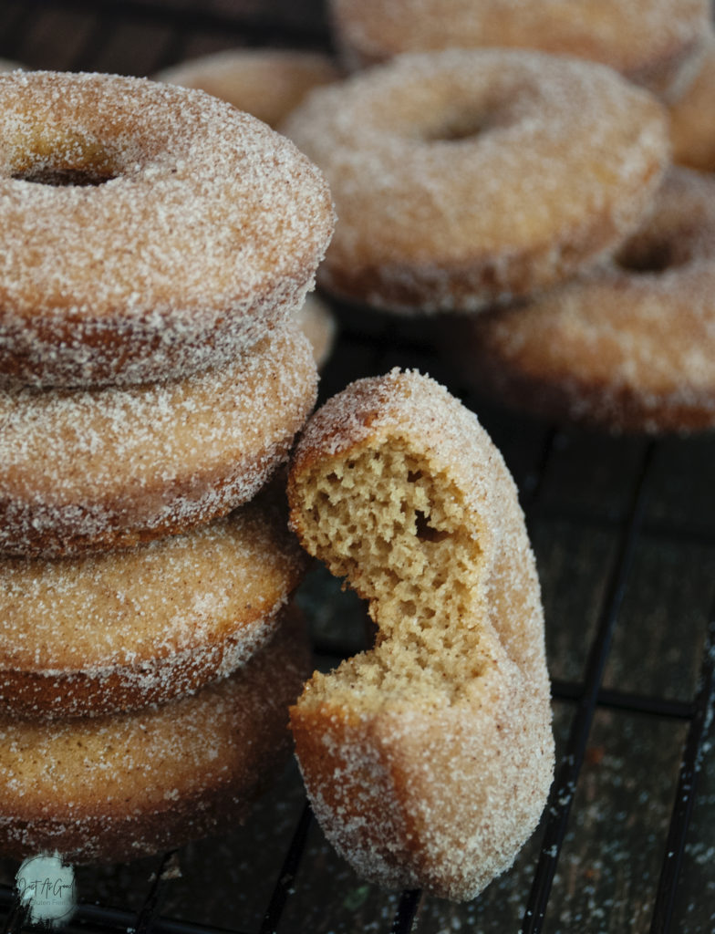 Stack of Gluten Free Baked Apple Cider Donuts with bite on side
