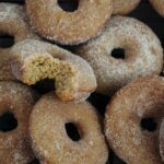 Stack of Gluten Free Baked Apple Cider Donuts with bite on side