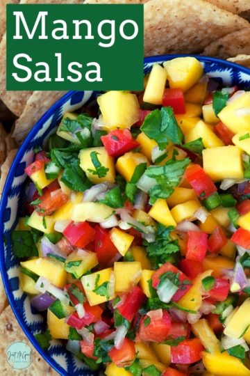 tortilla chips with a bowl of mango salsa