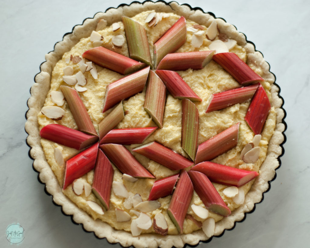 gluten free rhubarb frangipane tart before baking with rhubarb flower decoration