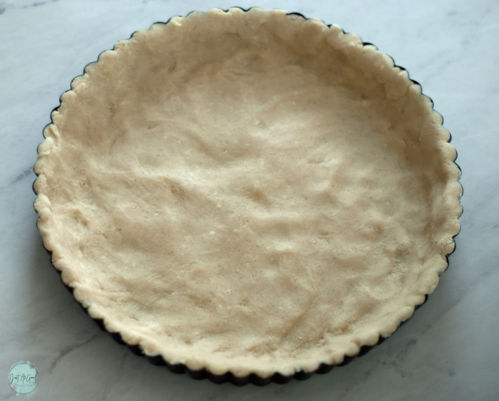 gluten free dough pressed into tart pan