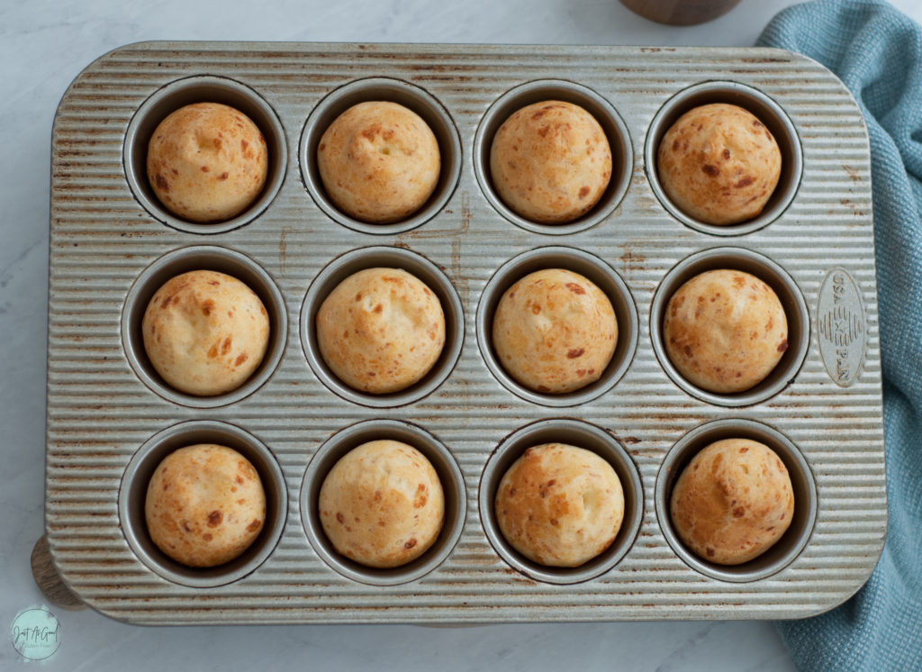 A muffin tin of baked Brazilian cheese bread rolls