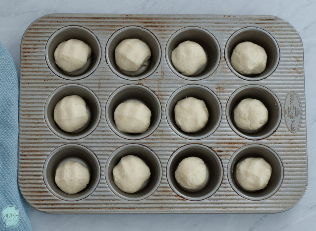 A muffin tin of unbaked Brazilian cheese bread rolls