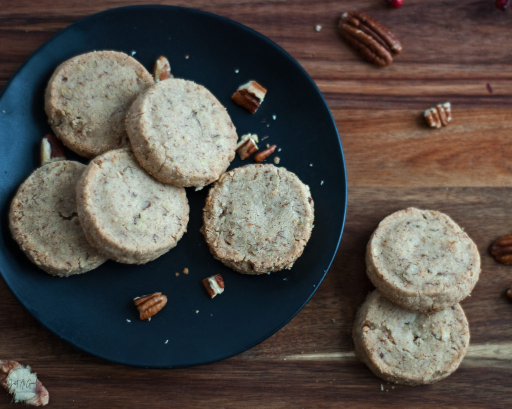 Gluten Free Pecan Shortbread Cookies on black plate and brown board