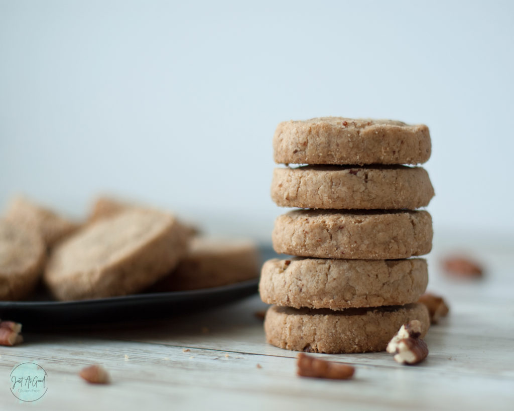 Gluten Free Pecan Shortbread Cookies stacked 5 tall in front of plate