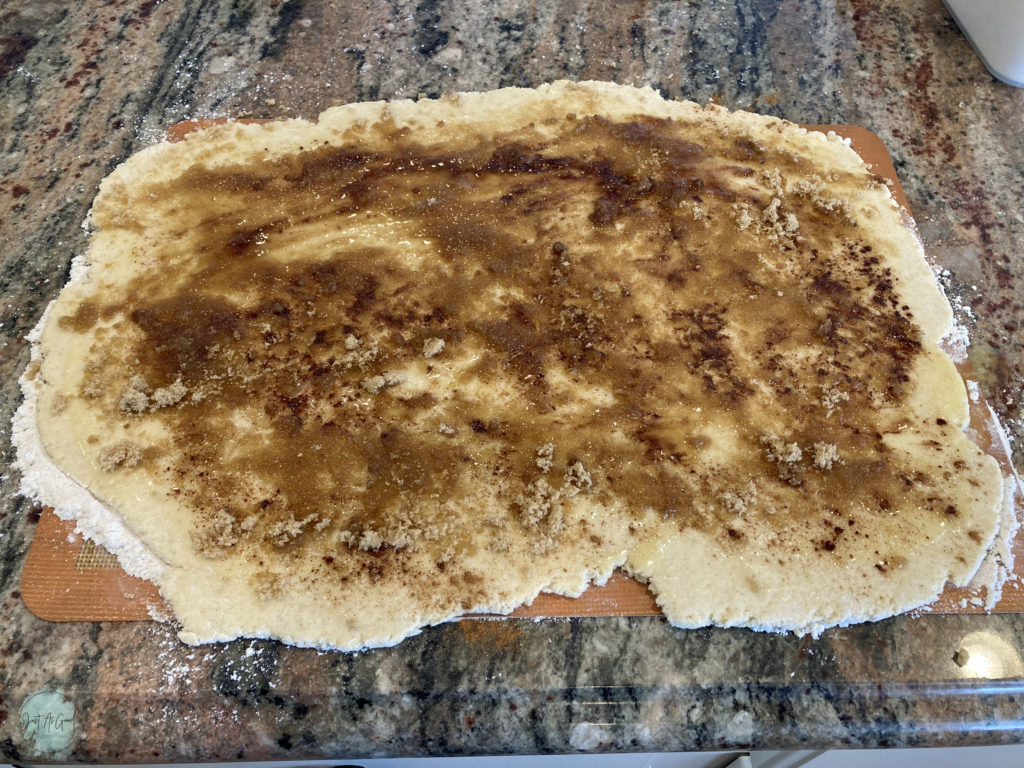 dough rolled out with filling of cinnamon, butter and brown sugar