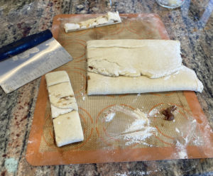 Gluten free Cinnamon Twist Buns dough being cut into strips
