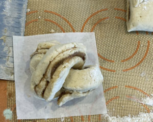 Gluten free Cinnamon Twist Bun Ball on parchment paper before baking