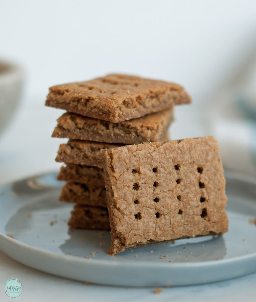 gluten free graham crackers stacked on plate with one tilted