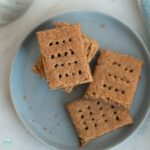 Stack of gluten free tiger nut graham crackers on blue plate