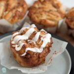 Gluten Free Twisted Cinnamon Buns on plate with drizzled frosting