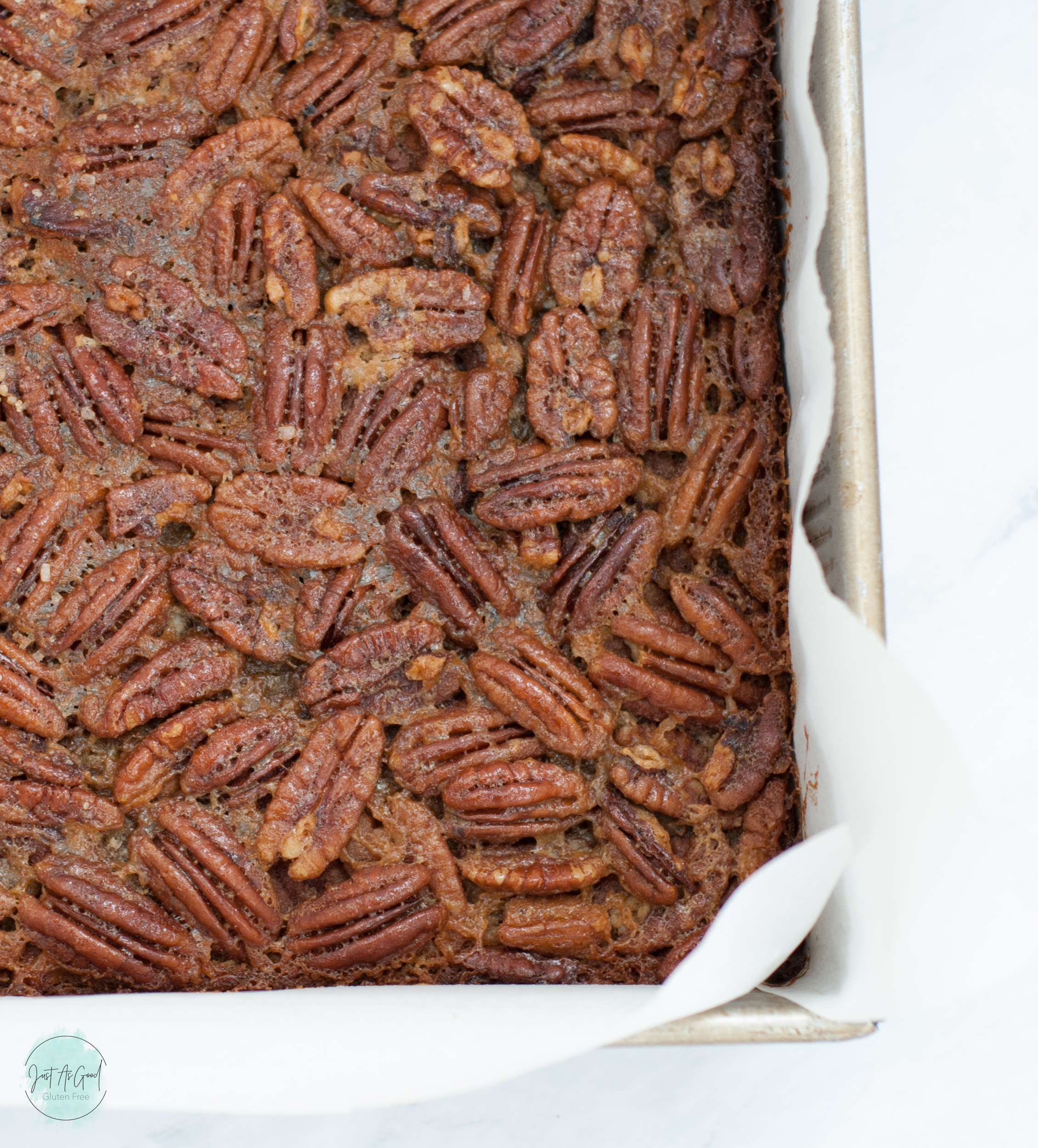 Corner of gluten free pecan pie bars in pan