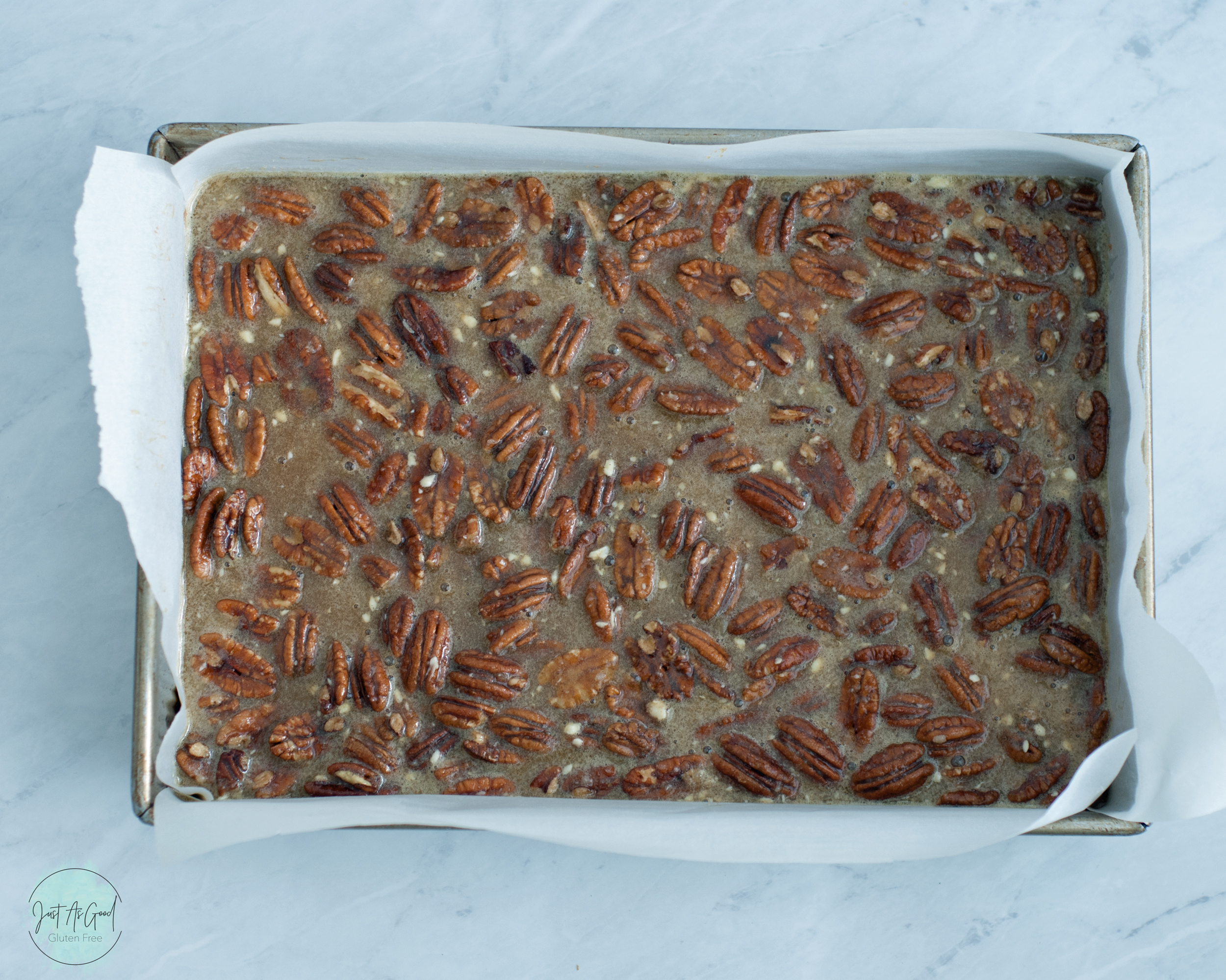 sheet pan of pecan pie bars before baking