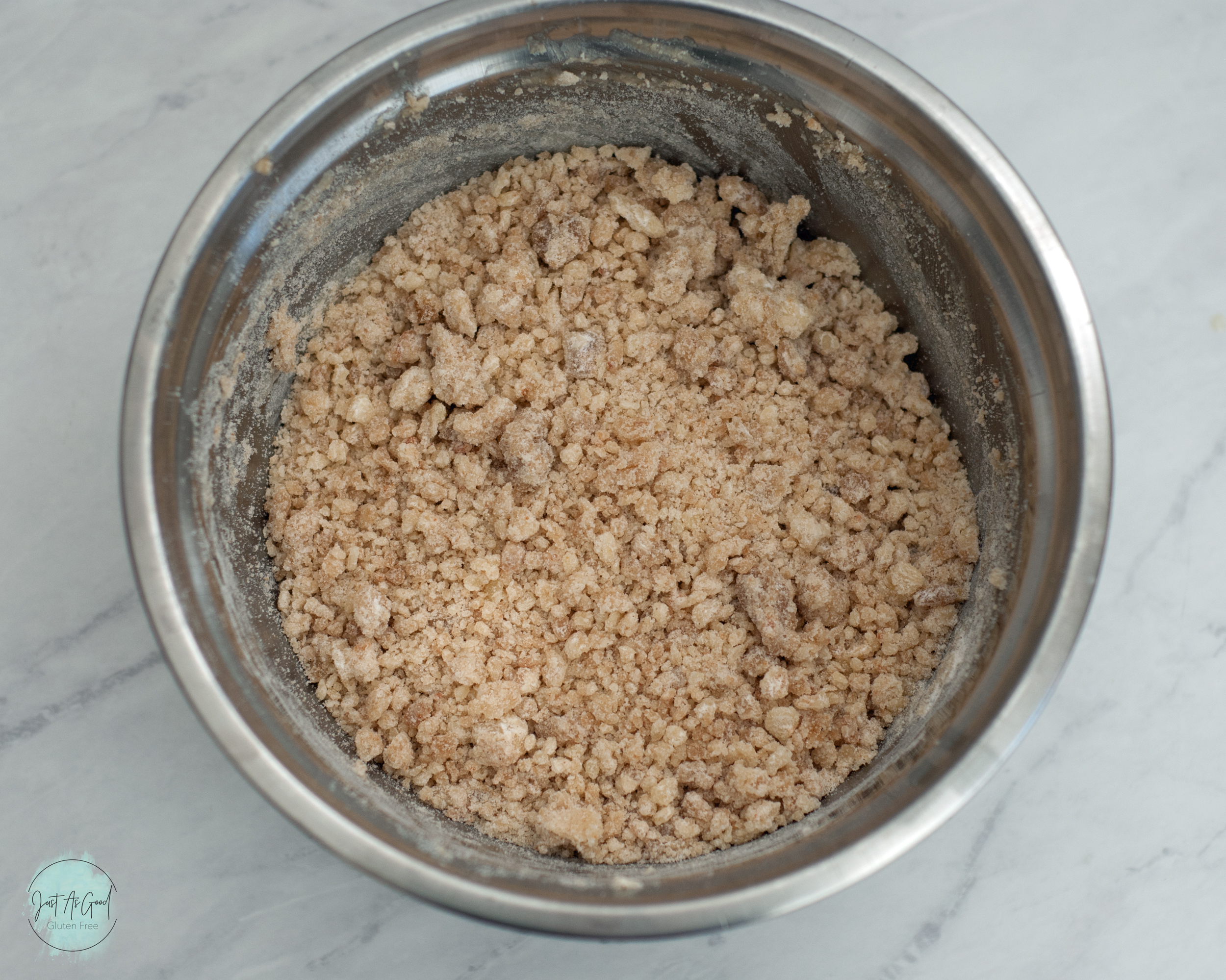 a bowl of crumbled flour and butter for dough base