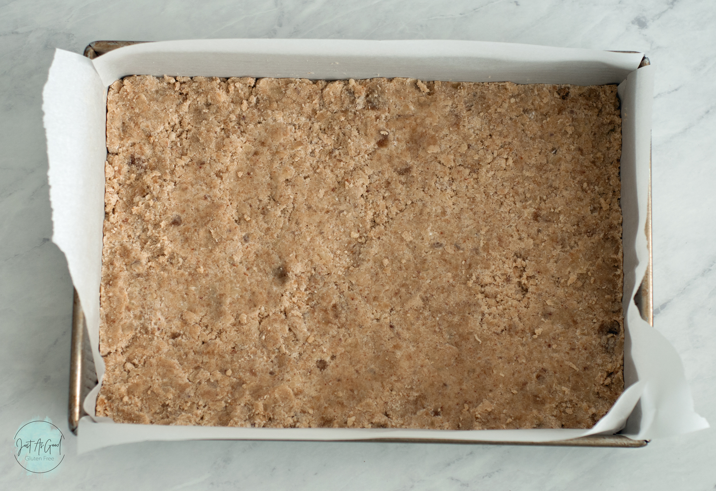 gluten free dough pressed in pan before baking