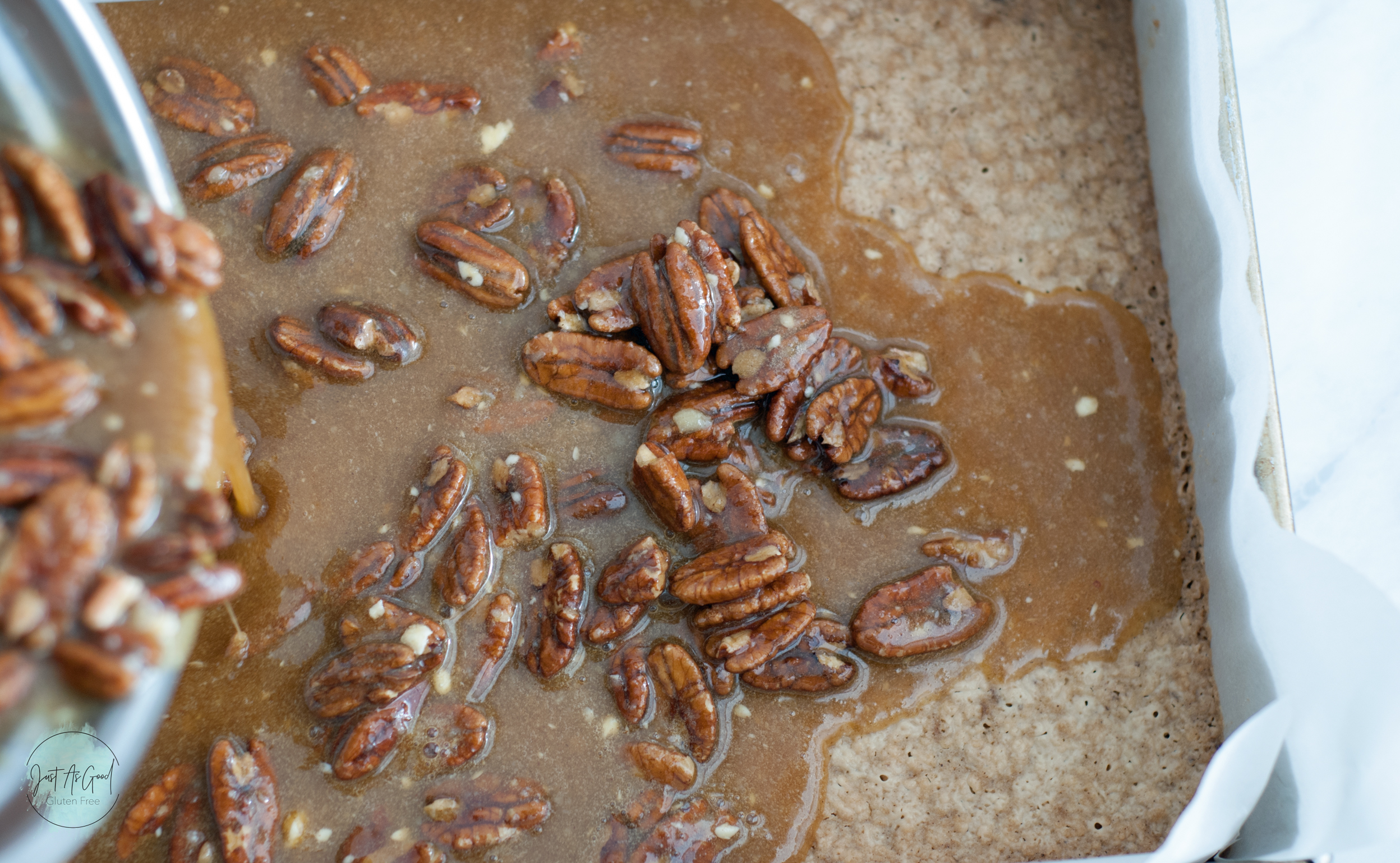 pouring pecan pie filling on gluten free crust