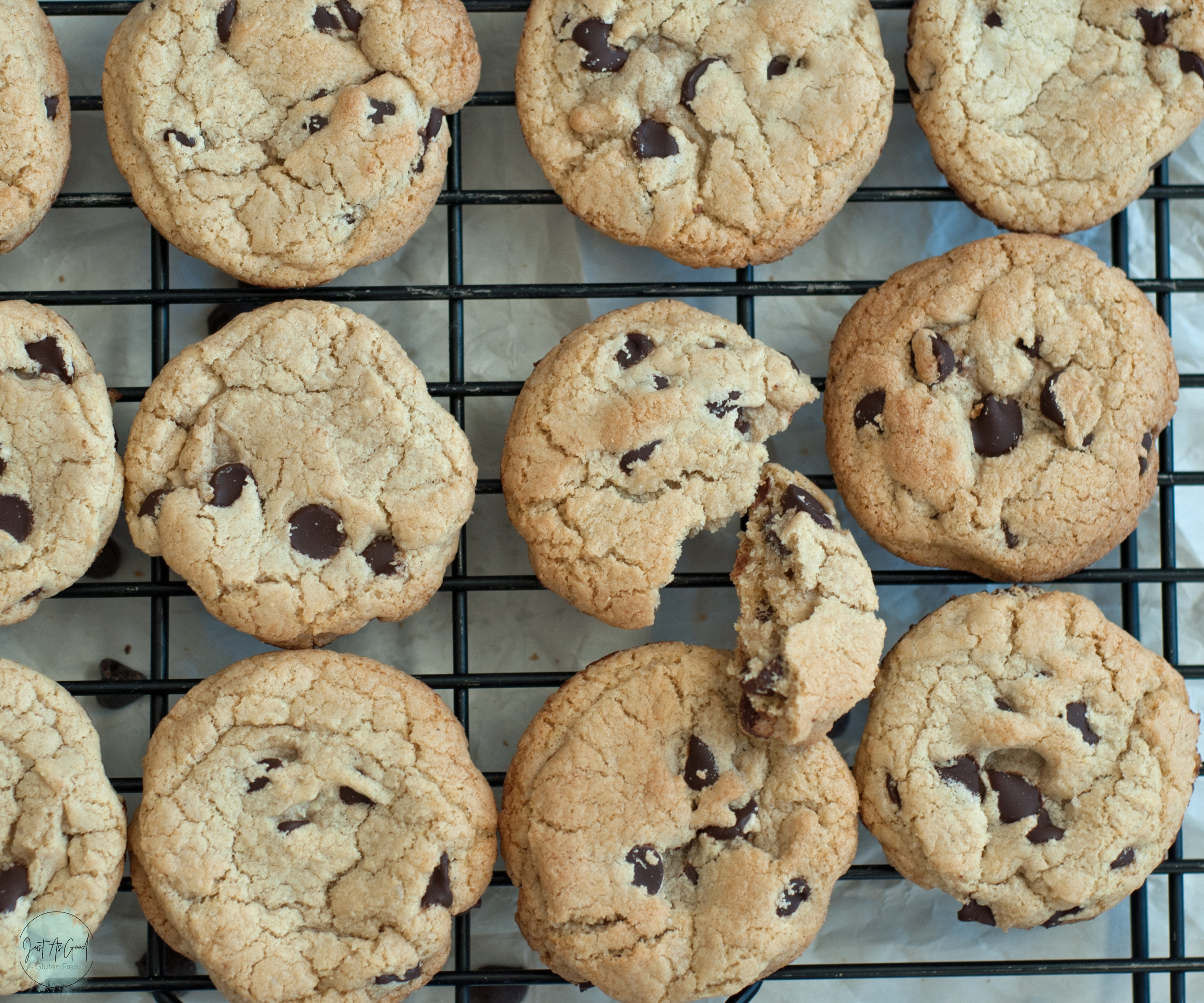 a bite out of a chocolate chip cookies on wire rack