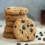 stack of five chocolate chip cookies with one tilted in front