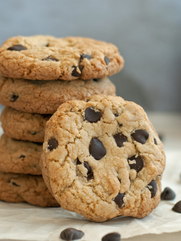 stack of five chocolate chip cookies with one tilted in front