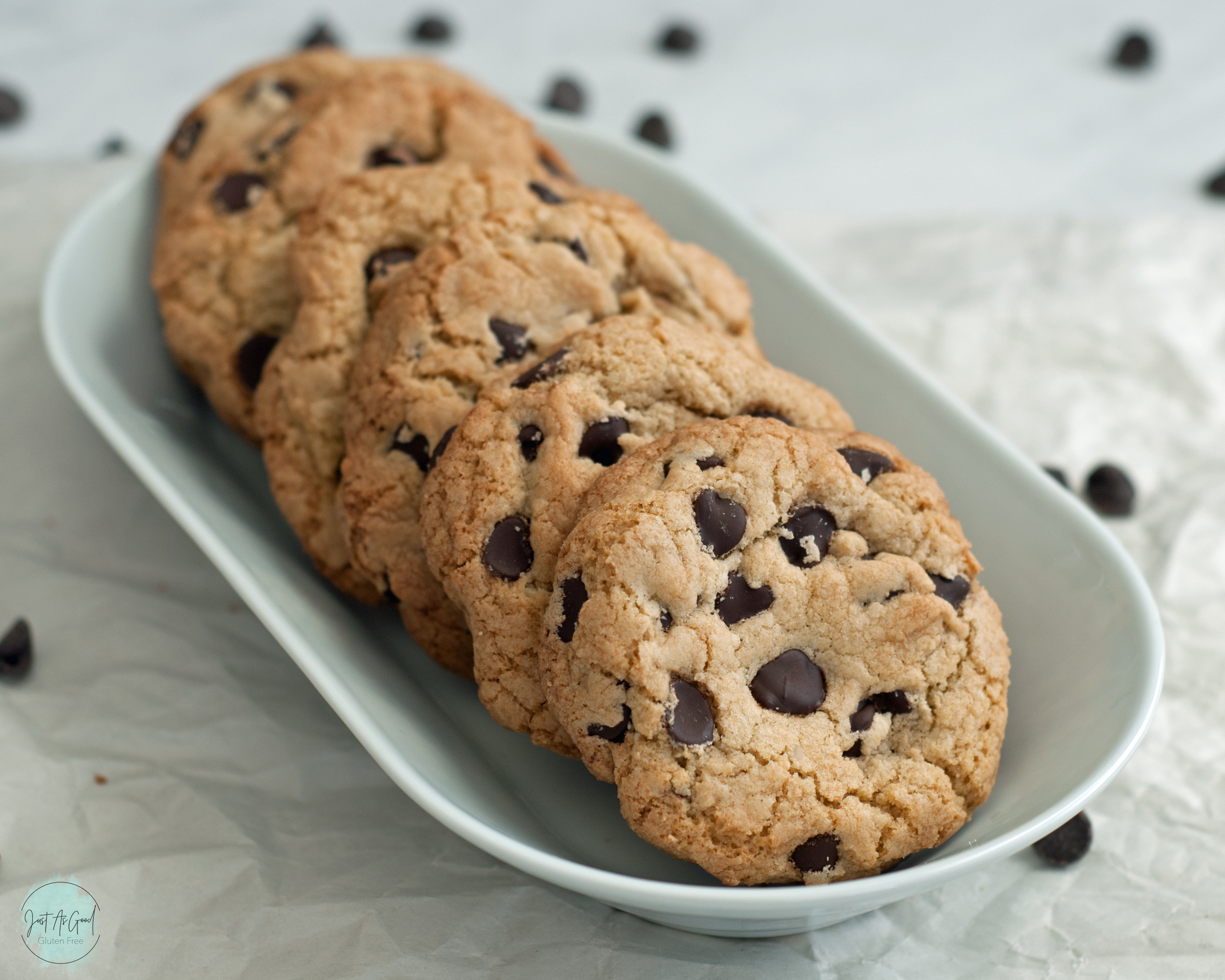 a row of chocolate chip cookies on white plate