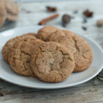 a plate of gluten free chai snickerdoodle cookies next to cookie rack