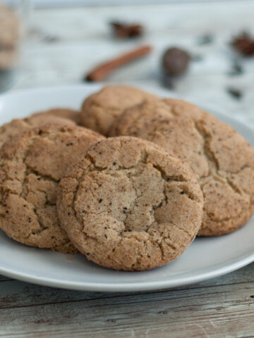 a plate of gluten free chai snickerdoodle cookies next to cookie rack