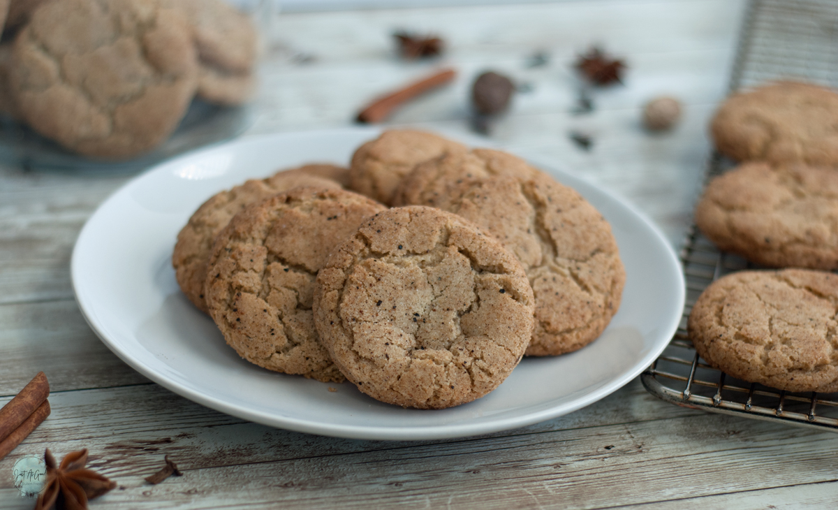 a plate of gluten free chai snickerdoodle cookies next to cookie rack